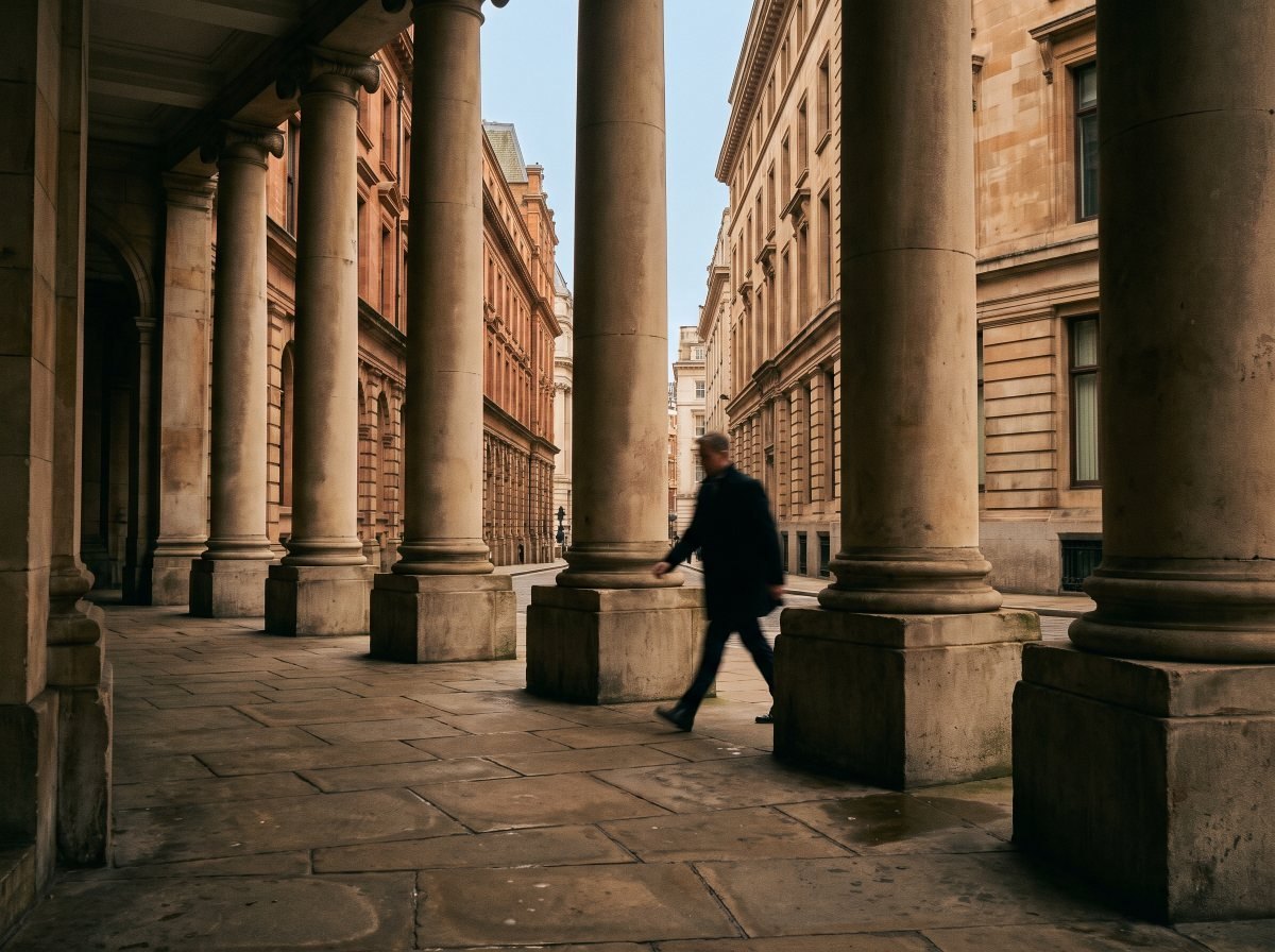 A stone colonnade in the City of London at early morning