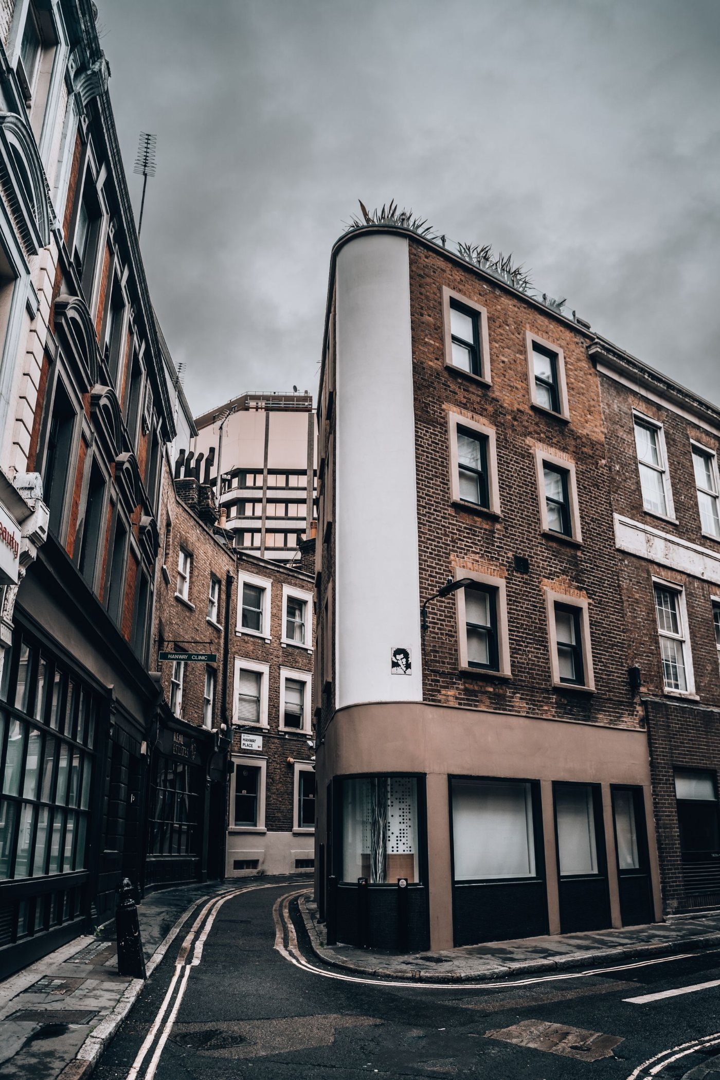 Narrow London streets framed by stone and brick office buildings on an overcast day